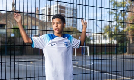 England’s united nations of football: 32 teams, one World Cup – and a lot of excited kids | World Cup 2022 15 Yeray Sanchez wearing an England shirt and standing against a metal fence with a playground behind it