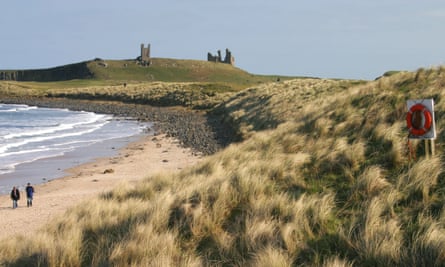 Beach, marram grass and castle in distance