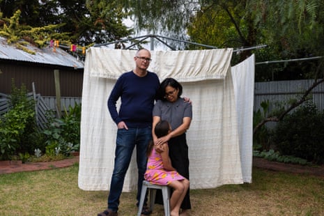 Adam, Doreen and their daughter Sophia* outside their home in St Morris in Adelaide