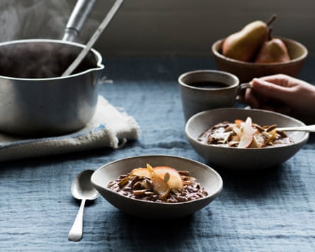 Two bowls of chocolate porridge topped with sliced pears