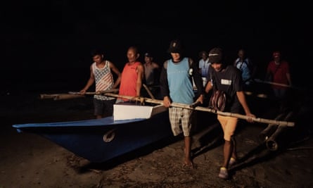 Members of the Bantay Dagat in the southern part of Negros Oriental province take their boat out for a night patrol