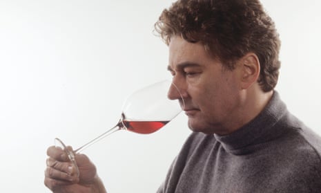 A man smelling a glass of wine
