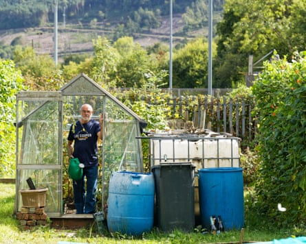 a man successful his greenhouse successful an allotment