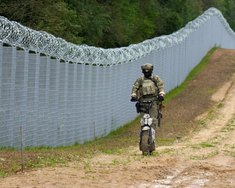 Latvian special unit Border Guard officer patrols along the fence at Latvia-Belarus border near Robežnieki, Latvia.