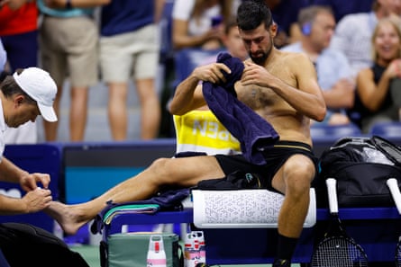 Djokovic receives medical attention.