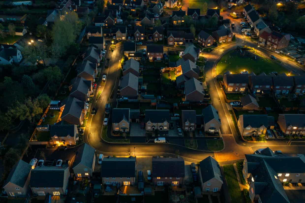 Aerial view of a UK suburban street lit up by streetlights
