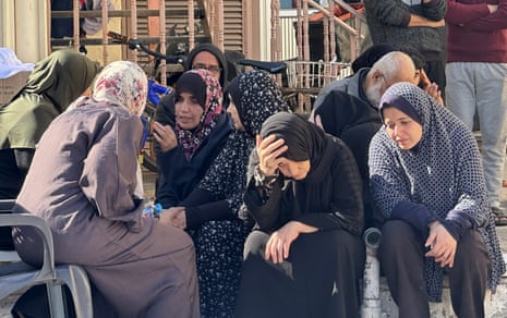 Relatives of Palestinians who lost their lives in Israeli attacks, mourn as the bodies are taken from morgue of Al-Aqsa Martyr’s Hospital to bury on the 46th day of Israeli attacks in Deir al-Balah, Gaza.