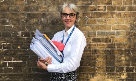 Lucy Kellaway, carrying a pile of marking at school.
