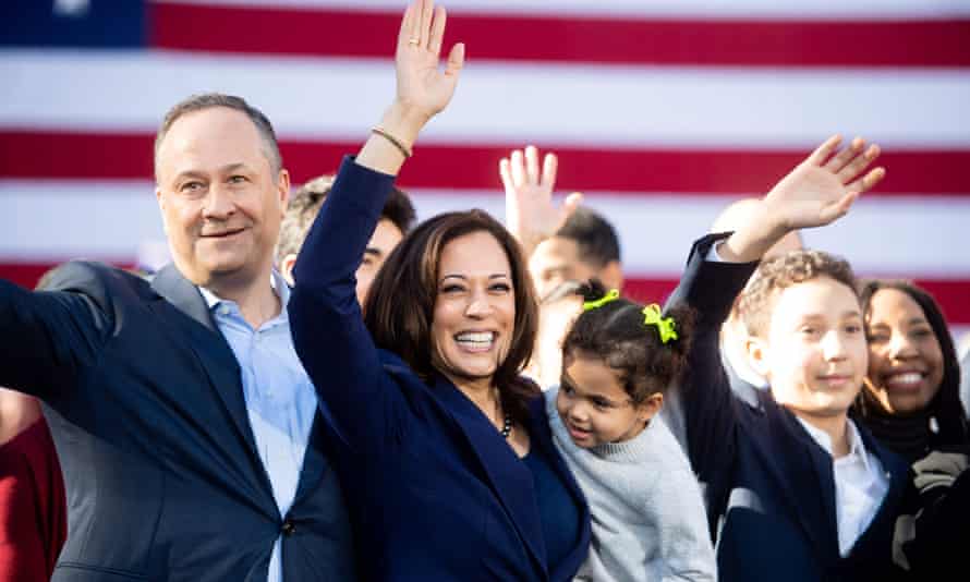 Kamala Harris waves next to her husband, Douglas Emhoff, during a rally launching her presidential campaign in January 2019 in Oakland.