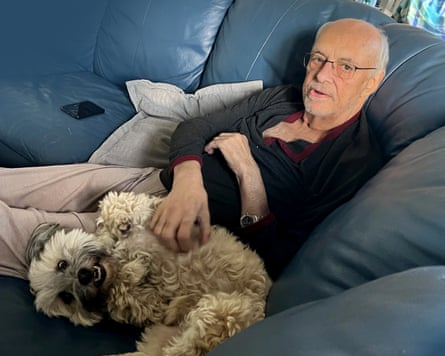 Alan with his service dog, Buddy seated on a couch