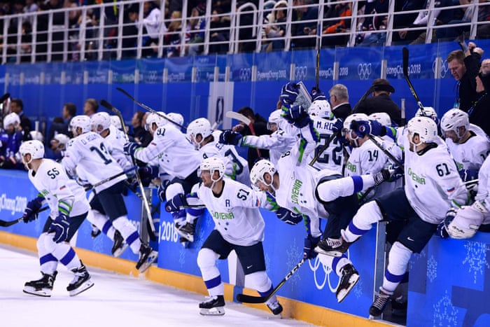 Team Slovenia rushes the ice after the overtime win over the USA.