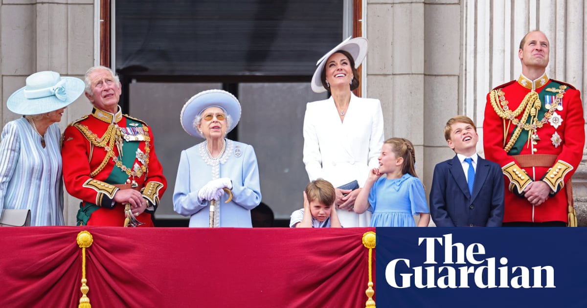 Royal family appear on Buckingham Palace balcony for flypast – video