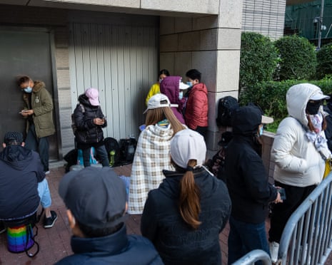 People wait to enter the the courts building