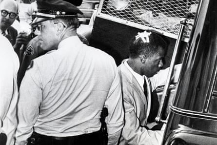 John Lewis enters a police van
