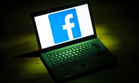 The logo of social networking site Facebook is displayed on a laptop.