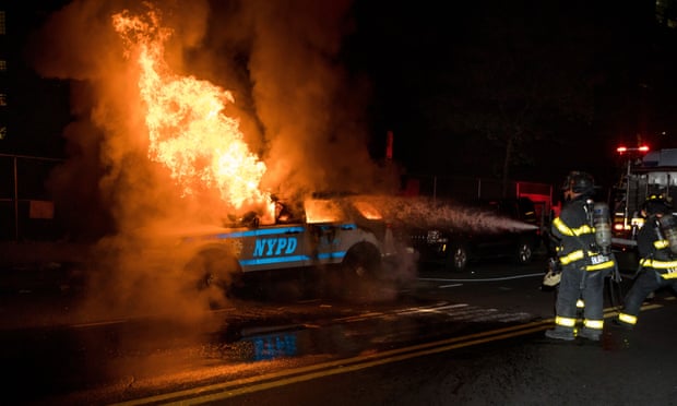 Firefighters put out a fire on a SUV of New York police department in the Brooklyn borough of New York.