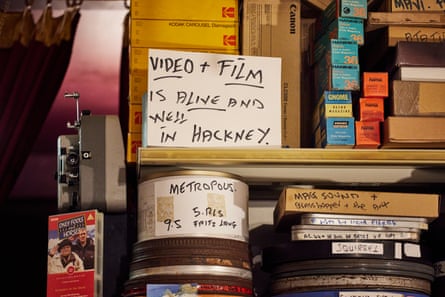 Videotapes jostle for space with movie posters and Kodak slide carousels.