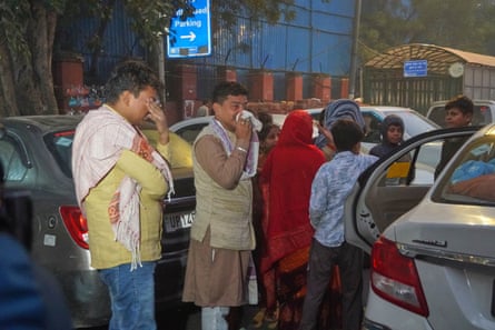People arrive to take the body of a relative from the mortuary of a hospital in Delhi.