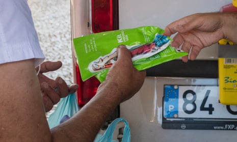 A patient receives syringes from a van parked in Lisbon after taking his daily dose of methadone.