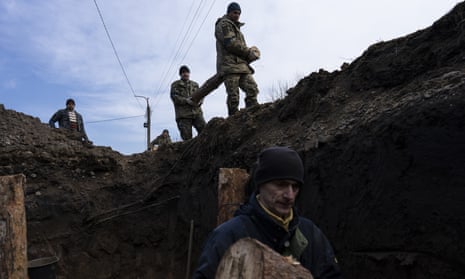 ‘Whatever hope is yours, / Was my life also’ … soldiers building a trench, in Lityn, Ukraine last month.