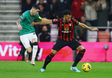 Lloyd Kelly holds off Miguel Almiron.