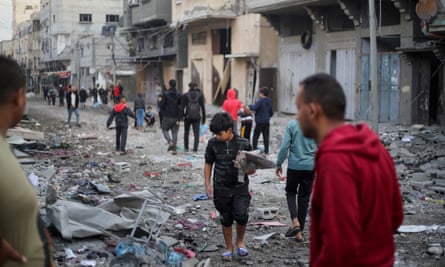 Palestinians inspect the site of Israeli strikes in Khan Younis.