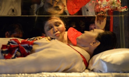 Former Philippine first lady Imelda Marcos kisses the glass case of her late husband in Batac town, Ilocos norte, north of Manila in 2014.