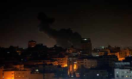 Smoke billows over buildings in Gaza City early Thursday morning