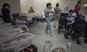Nannies take care of newborn babies in a basement converted into a nursery in Kyiv, Ukraine, Saturday, March 19, 2022. Nineteen babies were born to surrogate mothers, with their biological parents still outside the country due to the war against Russia.