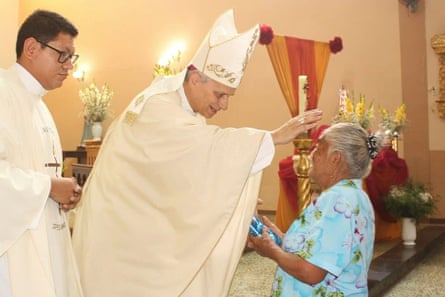 Bishop Robert Prevostblesses a woman during a Mass in Motupe, Peru, in September 2020.