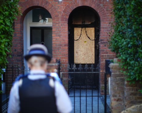 Police officer at entrance to house in Kentish Town after suspected arson attack