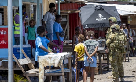 Australian soldiers talk with local citizens in Honiara. 