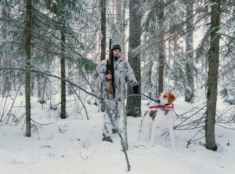 A hunter and his dog in the woods in North Karelia. Finland