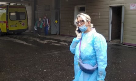 A medic speaks on the phone outside the hospital where Alexei Navalny is being treated in Omsk