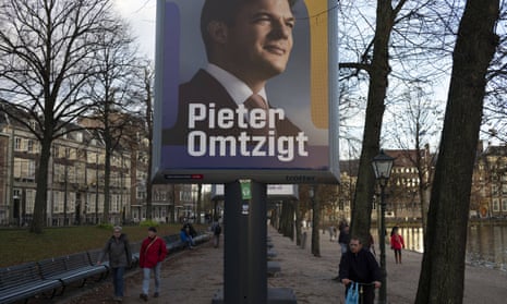 People walk past an election poster for Pieter Omtzigt, the candidate for the New Social Contract party (NSC) next to the Binnenhof in The Hague