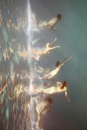 A stylised photo of naked men and women emerging from water