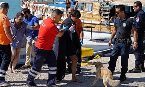Paramedics attend to refugees rescued at the port of Mytilene on the island of Lesbos. 