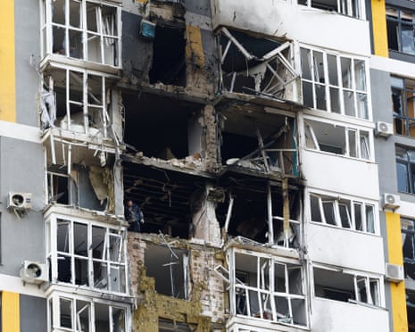 A resident removes debris inside of an apartment building hit during an overnight Russian drone and missile strikes, amid Russia's attack on Ukraine, in Kyiv, Ukraine.