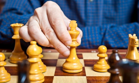 chess player hand playing a king move