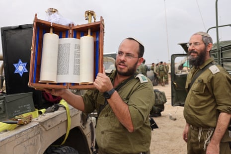 An Israeli army religious officer stationed along the border with the Gaza Strip prepares to transport a Sefer Torah to Gaza on 28 December.