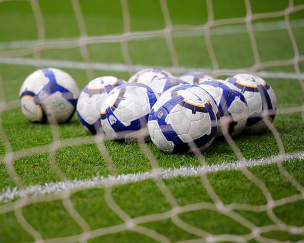Some footballs in a net