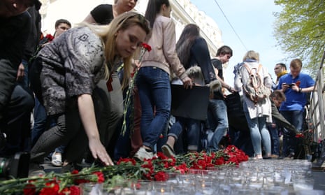 People lay flowers outside the Ukrainian embassy in Moscow in memory of the victims of the 2014 Odessa clashes.