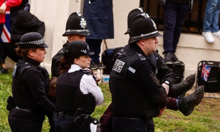 Officers detain a Just Stop Oil protester