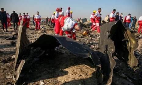 Red Crescent workers check the debris from the Ukraine International Airlines plane that crashed after take-off from Iran’s Imam Khomeini airport