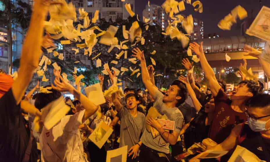 Anti-government protesters throw fake money in the air as a form of protest on Friday