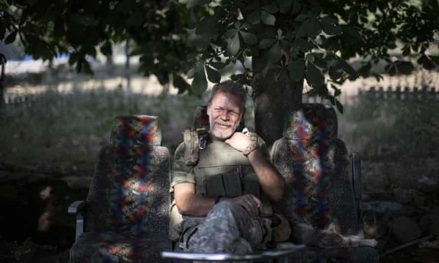 A Ukrainian serviceman poses for photo in Verkhnokamyanske frontline, Ukraine, 4 July.