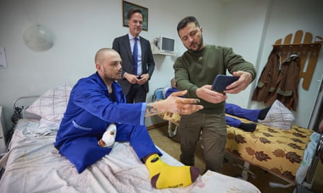 Volodymyr Zelenskiy and Mark Rutte pose for photo with the a wounded Ukrainian soldier in a hospital in Odesa.