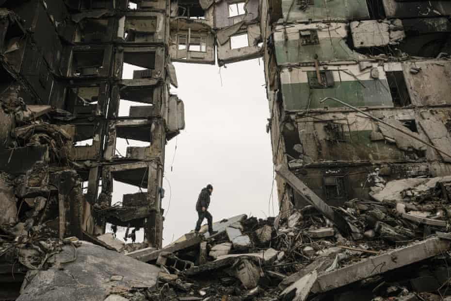 A resident looks for belongings in an apartment building destroyed during fighting between Ukrainian and Russian forces in Borodyanka, Ukraine, on Tuesday