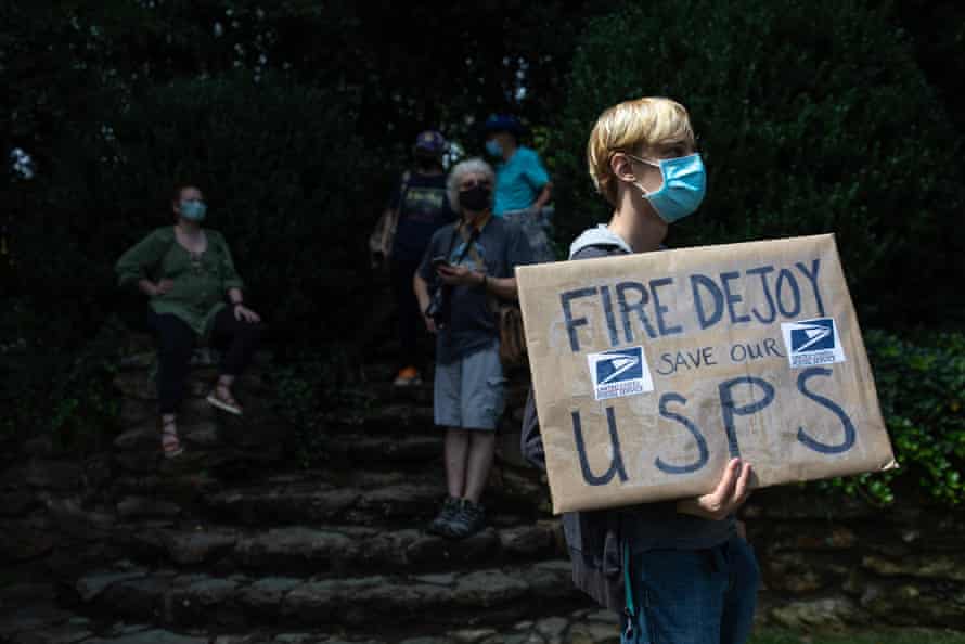 A group of protestors hold a demonstration in front of Postmaster General Louis DeJoy’s home in Greensboro, North Carolina on August 16, 2020. -