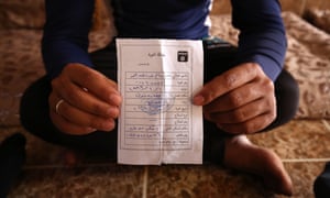 A former Iraqi Army member holds the ‘repentance card’ he received from Islamic State after militants took over his home in Eski Mosul, northern Iraq.